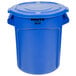 A blue Rubbermaid BRUTE round plastic trash can with the lid open.