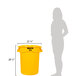 A woman standing next to a yellow Rubbermaid BRUTE trash can with a lid.