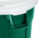 A green and white Rubbermaid BRUTE 55 gallon trash can with a white lid.
