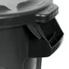 A black Rubbermaid BRUTE trash can with a lid.