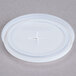 A translucent plastic lid with a cross on top.