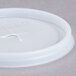 A translucent plastic lid with a cross-shaped hole.