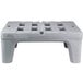 A gray plastic bench with holes.