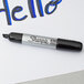 A Sharpie King Size black chisel tip marker writing "hello" on white paper.