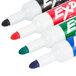 A group of Expo low-odor dry erase markers in red, blue, green, and black.