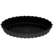 A black fluted oblong tartlet pan with a white background.