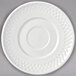 A white Libbey porcelain saucer with a circular pattern on it.