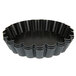 A black baking pan with wavy edges.