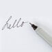 A close-up of a Sharpie Ultra-Fine Point marker with the word "hello" written in black.