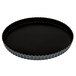 A black Matfer Bourgeat fluted tart pan with a removable bottom.