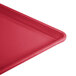 A close up of a red Cambro dietary tray with a corner.