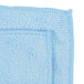 A light blue Carlisle microfiber cleaning cloth.