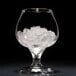 A white glass with Hoshizaki flake ice inside.