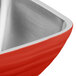 A close up of a fire engine red stainless steel Vollrath serving bowl.