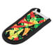 A Lodge chili pepper pot holder with multi-color peppers on it.