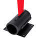 A black cylinder with a red strap attached to it.