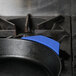 A blue Lodge silicone handle holder on a cast iron pan.