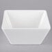 A white square Vollrath melamine bowl with a lid.
