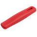 A Lodge red silicone handle holder with a hole for a skillet handle.