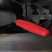 A red silicone handle holder on a Lodge carbon steel skillet.
