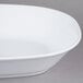 An American Metalcraft white melamine serving bowl on a gray surface.