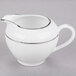 A white porcelain pitcher with a silver double line.