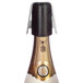 A close-up of a bottle of champagne with a black cap being opened using a Franmara champagne combo opener.