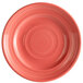 A pink Tuxton Concentrix china plate with a spiral pattern.