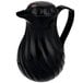 A black plastic jug with a handle.