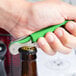 A hand using a Pulltap's Original green waiter's corkscrew to open a bottle.