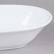 An American Metalcraft white melamine serving bowl on a gray surface.