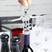 A hand using a Franmara Tavern Wing Corkscrew to open a bottle of wine.