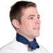 A man wearing a navy blue chef neckerchief around his neck.