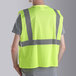 A person wearing a Cordova lime high visibility safety vest.