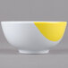 A white melamine bowl with yellow stripes.
