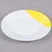 A white melamine plate with a wide yellow rim.