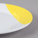 A white GET Bold melamine plate with a yellow rim.