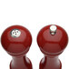 A pair of Chef Specialties candy apple red pepper mills with silver tops.