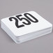 A stack of American Metalcraft plastic table number cards with the number 250 on top.