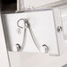 The metal hook attached to a Doyon countertop dough sheeter.