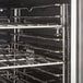 A stainless steel oven rack in a Cooking Performance Group double deck convection oven.