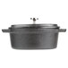 An American Metalcraft pre-seasoned black cast iron oval dutch oven with a lid.
