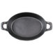 A black pre-seasoned cast iron oval casserole dish with two handles.