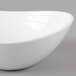 A close-up of a GET Magnolia melamine bowl with a textured rim on a white background.