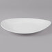 A white oval melamine platter with a textured rim.