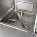A close-up of a Hobart undercounter dishwasher with a metal door.
