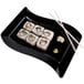 A black Fineline plastic plate with sushi and chopsticks on it.