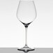 A clear Spiegelau Superiore Burgundy wine glass on a table.