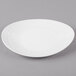 An ivory oval melamine platter with a textured rim.