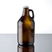 A close-up of a brown Libbey glass growler with a white lid.